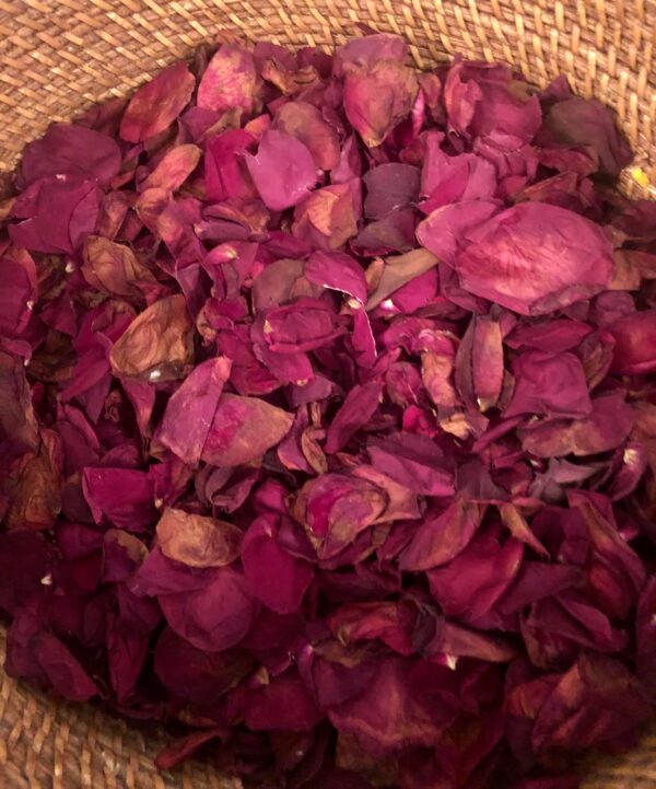 red dried rose flower petals in a brown basket