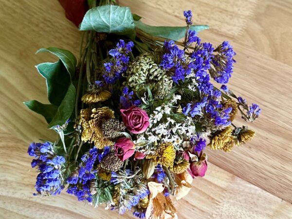 colorful dried flowers in a bouquet on a wood table